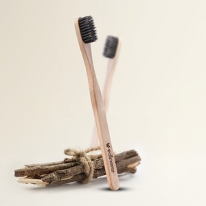 Edinora soft toothbrush with clove infused neem wood handle - tapered, charcoal infused bristles